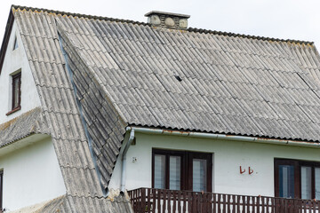 roof covered with grey asbestos tiles