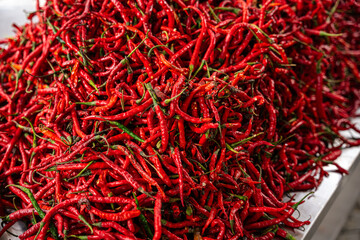 pile of Fresh Chilies and Ripe Red Chilies in Baskets for Sale at the Vegetable Market