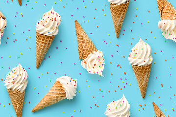 Seamless pattern of vanilla ice cream cones on a blue background. Summer ornament concept for backgrounds, textiles and wrapping paper and wallpapers