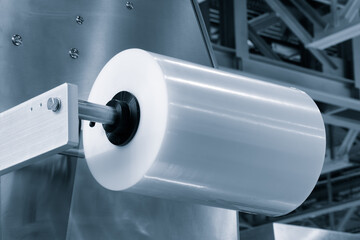 Automatic polyethylene plastic bag production machine with lighting effect. Close-up of the roller...
