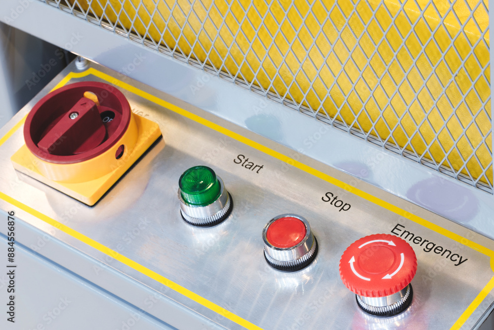 Poster a red, green, and yellow button panel with the words start, stop, and emergency. the buttons are arr