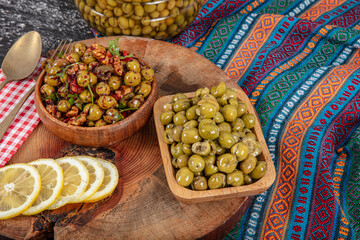 Homemade crushing olive making. Fresh green olives are breaking one by one. Crushing olives with...