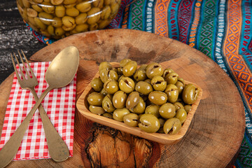 Homemade crushing olive making. Fresh green olives are breaking one by one. Crushing olives with...