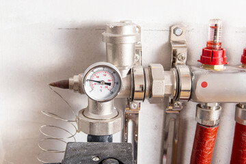 Water underfloor heating. Hinges of the water underfloor heating. Pressure gauge closeup. Supply...