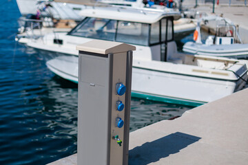 Fototapeta premium Electrical outlet and boat docked at marina