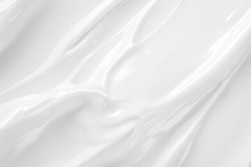 A white background with a smooth, shiny, and silky texture. The image is of a cream or lotion, which is applied to the skin. The cream is spread evenly across the surface