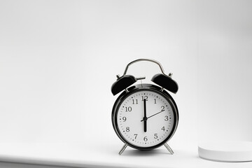Clock, alarm clock on a light background. Six hours on a retro watch. Close-up