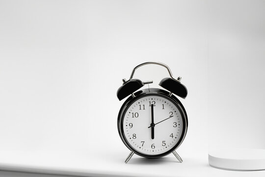 Clock, alarm clock on a light background. Six hours on a retro watch. Close-up