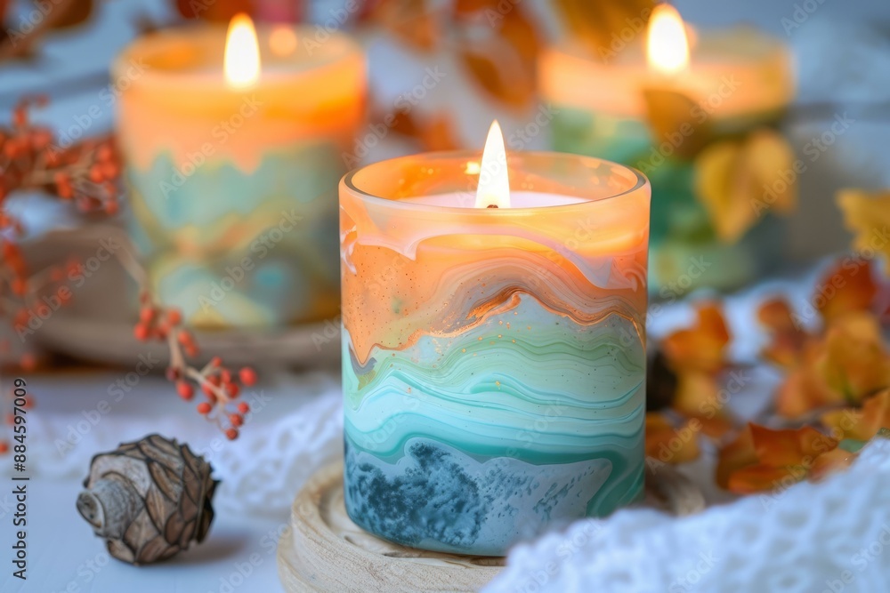 Poster lit scented candle adds warmth to an autumnal setting with leaves and soft light