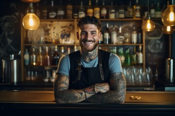 Smiling portrait of a young tattooed male bartender