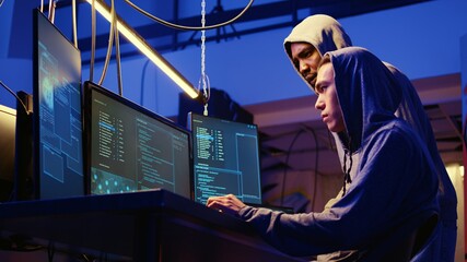 Hackers brainstorming ways of getting past anti tamper measures implemented by companies trying to...