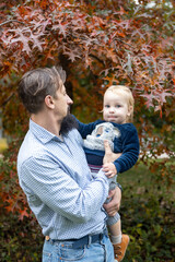 Young father with his son in the autumn park. The concept of a happy family.