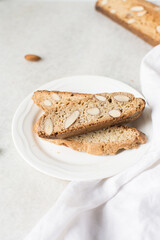 almond biscotti on a white plate, almond cantucci cookies on a white plate, biscotti cookies or twice baked cookies