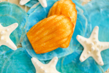Madeleine cookies set and nautical decor.Madeleine biscuit on blue mother of pearl and white...