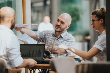 Startup team in a business meeting discussing, brainstorming, analyzing data, and strategizing. Collaborative group working together to achieve business goals.