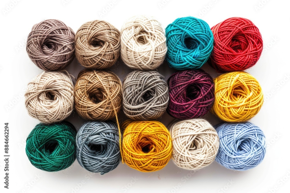 Poster A collection of colorful yarn balls arranged neatly on a white surface, perfect for craft or design projects