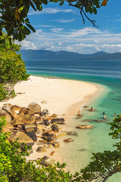 Picturesque tropical golden Nudey Beach with turquoise water on Fitzroy Island. It is a continental island southeast of Cairns, Queensland, Australia.