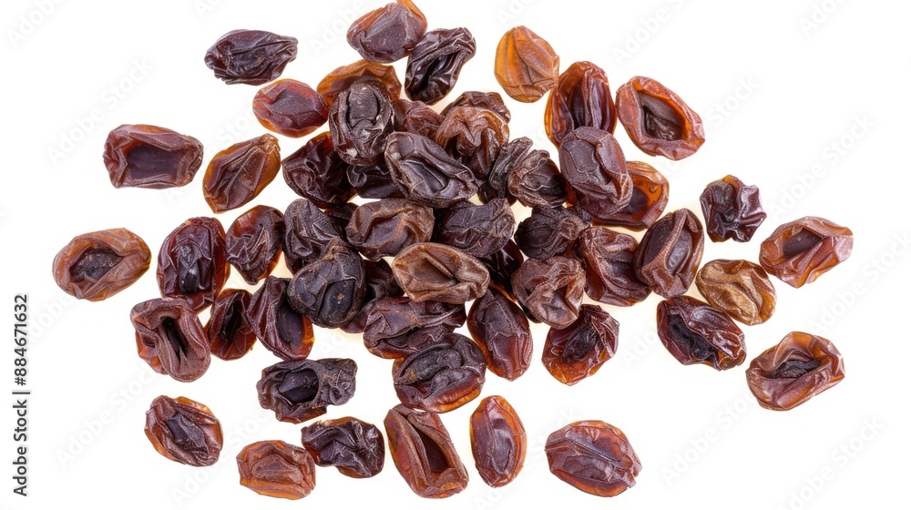 Poster a pile of dried raisins on a white surface, perfect for close-up shots or adding texture to your des