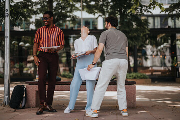 Diverse group of colleagues laughing and taking a break in urban setting. Relaxed atmosphere, teamwork, and casual conversation in outdoor business environment.