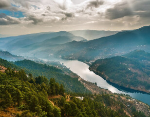 An aerial view of a vast reservoir nestled amidst rolling hills and mountains