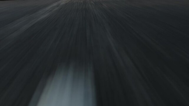 Fast Low angle POV driving on asphalt road with lane markings