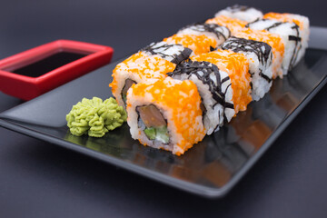 Sushi Composition with Soy Sauce and Wasabi on Dark Background