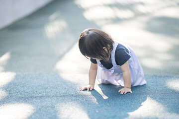 A one-year-old Chinese Malaysian girl playing on the children's playground equipment at KLCC Park...