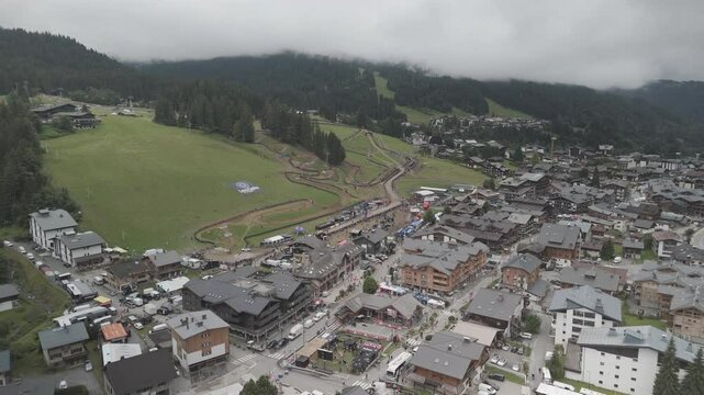 Footage filmed in France, in a village named Les Gets in the Alpes with DJI Mini 4 pro in 4k and D-Cinelike. Forward movement.