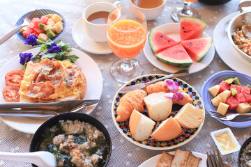 Breakfast set at outdoor table on holiday vacation. Summer outdoor party arrangement, romantic date resort. Holiday vacation