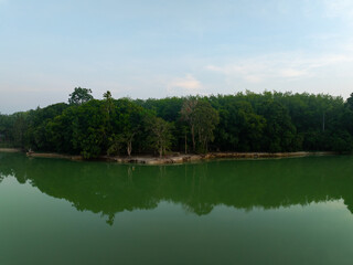 Beautiful landscape nature view sunrise morning with reflections light over water surface during sunrise scenery mountain background