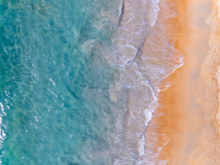 Aerial top view nature background of waves crashing in the ocean sea water, Drone view of sea waves in bird eye view photo,Beach sea background