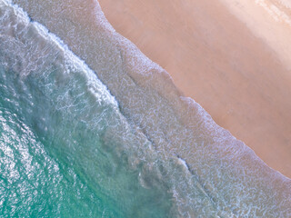 Aerial top view nature background of waves crashing in the ocean sea water, Drone view of sea waves in bird eye view photo,Beach sea background