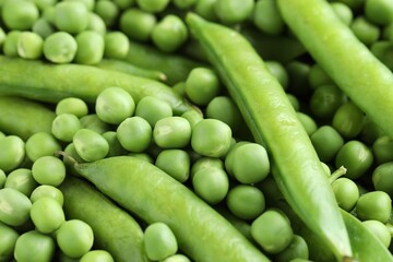 Many fresh green pods and peas as background, closeup