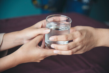 Woman drinking water hands holding cold mineral water cool drinking. Asian women smile laugh look away health care home fitness lifestyle. Cheerful Beautiful female drink glass of water smile face