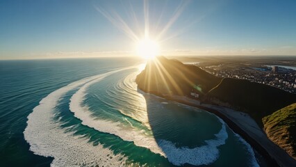 Naklejka premium Aerial View of Sunset Over Ocean Waves and Coastal Town.