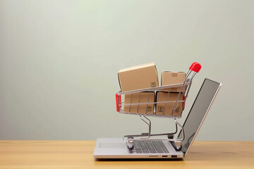 Online shopping concept with cart full of boxes on top of laptop computer
