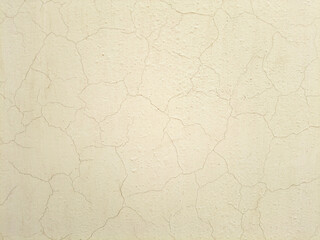 Off white creamy wall texture background with paint cracks, paper texture background, wall cracks.