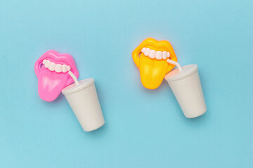Colorful Plastic Lips and Cups on Blue Background - Quirky and Fun Conceptual Image