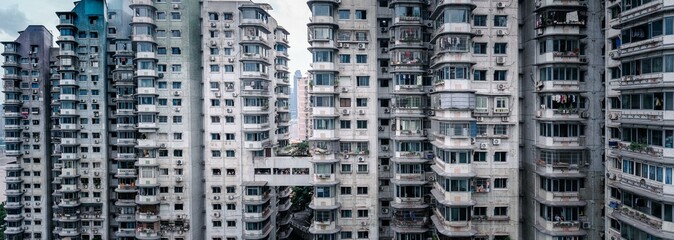 Dense high-rise residential buildings in China, with numerous windows and balconies, showcasing...