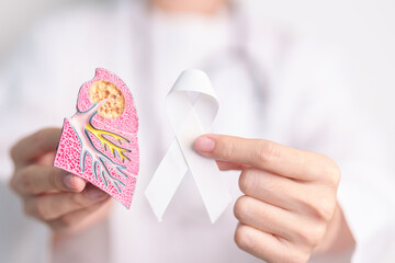 November Lung Cancer Awareness month. Doctor with Smoker Lung anatomy model and White ribbon in hospital. Healthcare and World Cancer day concept