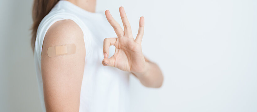 Woman with bandage after receiving vaccine. Vaccination and Immunization for Influenza, HPV, Zoster, IPD, DTP or Diphtheria, Tetanus and Pertussis, MMR, Hepatitis B, Covid  and Varicella vaccine
