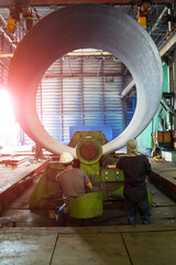 Technician is working bending steel  with machine. Pipe with out seam formed by roll bending of...