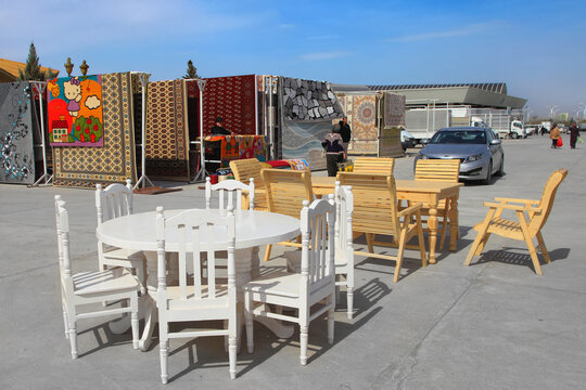 Ashgabat, Turkmenistan market - Mart 15.2020: Handmade wooden furniture and swings for summer cottage or yard