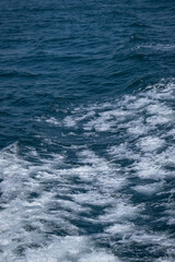 Waves and white foam on the sea as the ship sails