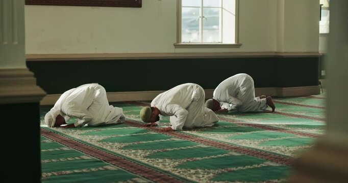 Muslim, religion and men in mosque for prayer, salah and worship on floor in holy temple. Islamic community, Palestine and people in religious building for Ramadan Kareem, Eid Mubarak and praying