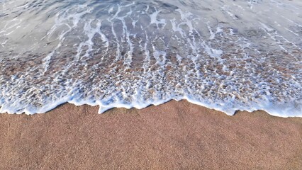 views of sandy beaches and high tides with white foam. Taken from a high angle in the morning on a beach in Pacitan, East Java. No people.

