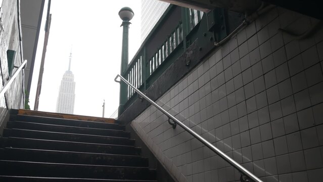 New York City underground subway globe, metro orb lamp. Empire State building. Metropolitan entrance stairway, Manhattan, 34 st. Midtown financial business district. Public transport station stairs.