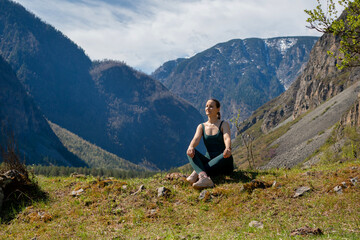 Fototapeta premium Woman meditating, zen yoga meditation practice in nature. Yogi girl is sitting in lotus pose, healthy lifestyle, meditation concept