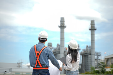 Planning engineering and project leader working and check Plans at Industrial Site on power plant. Survey location on site. 