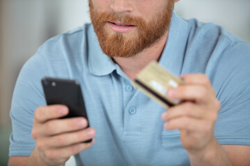 smiling man making order by mobile phone